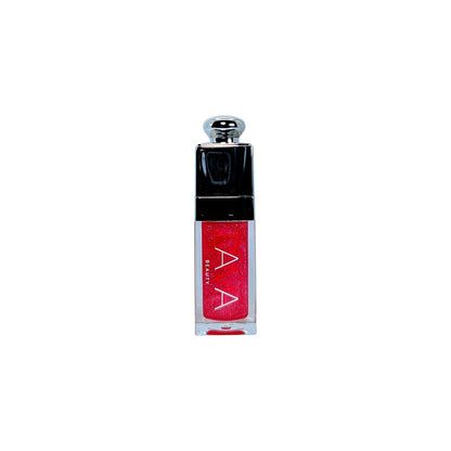 Red lip oil with black cap on a white background