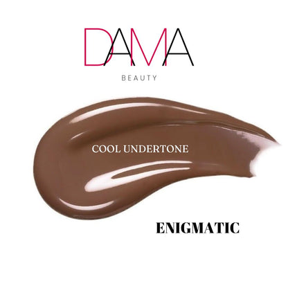Brown makeup swatch labeled 'Enigmatic' with 'DAMA Beauty' branding on a white background